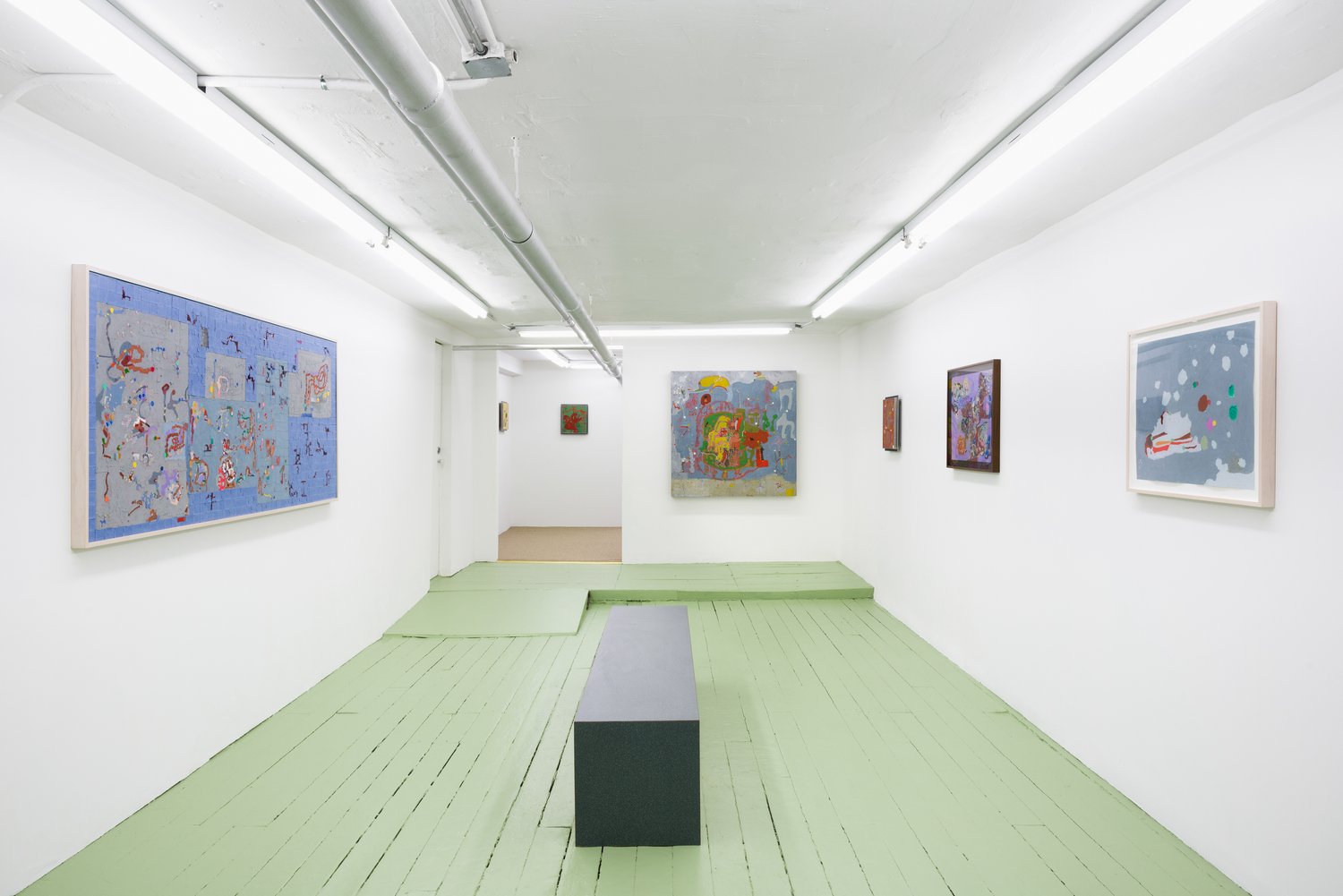 An installation view of the paintings in an exhibition.